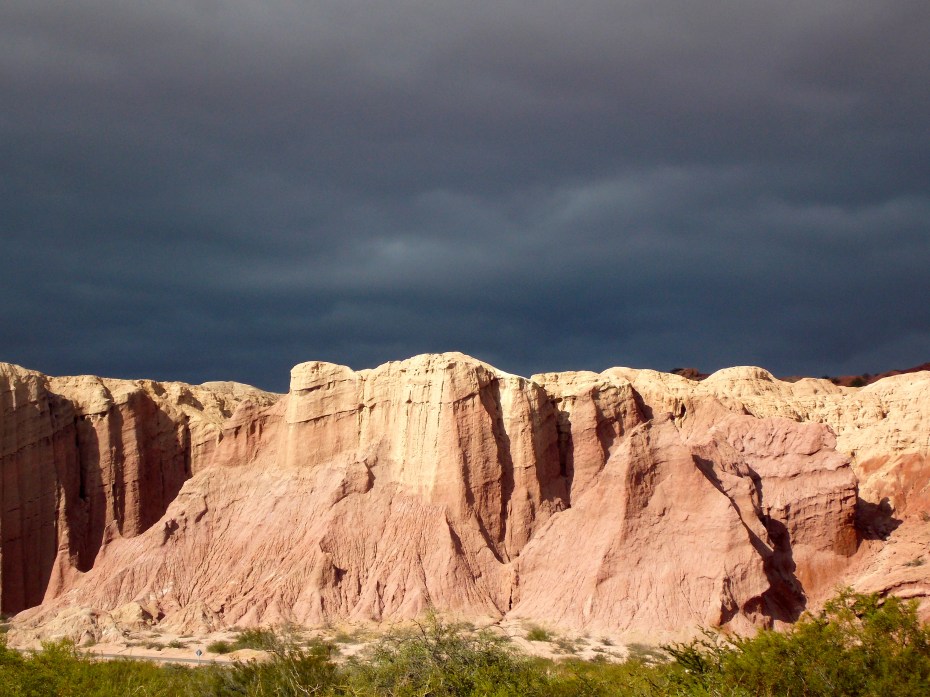 Sun on the cliffs, ominous sky.