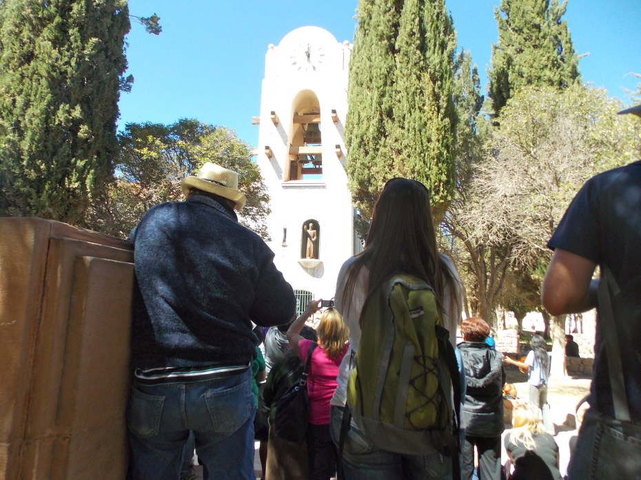 The mechanical priest blesses the crowd. 